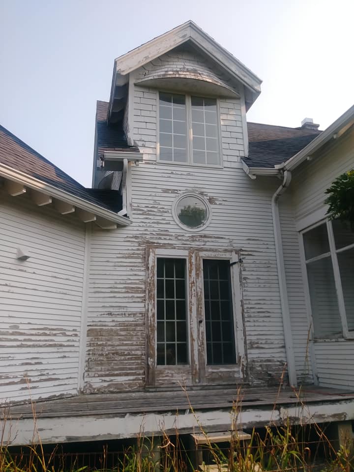 scraping paint off house