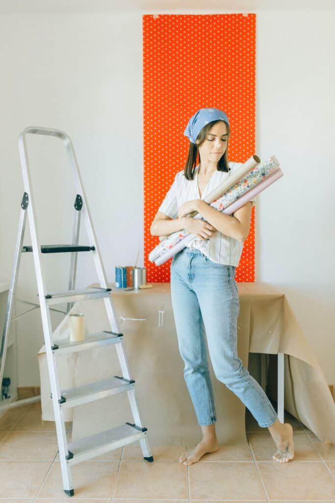 Woman preparing to hang wallpaper